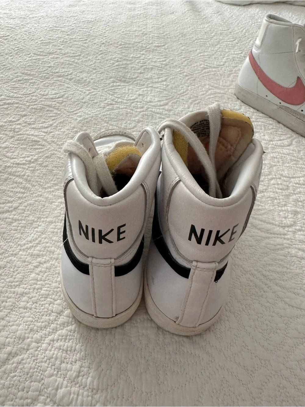 Nike White High-Top Sneakers with Black Swoosh and Orange Tongue Accent
